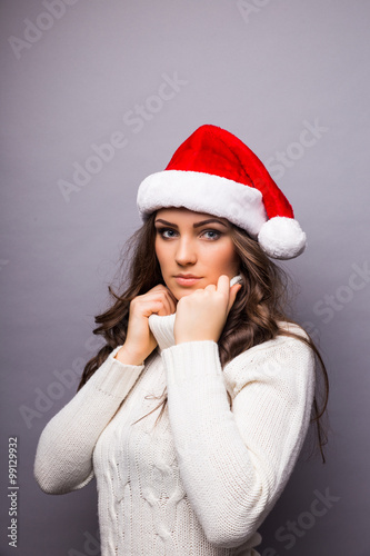 Beautiful happy young Caucasian brunette woman wearing Santa Claus beanie hat . Christmas concepts. Isoleted on white.