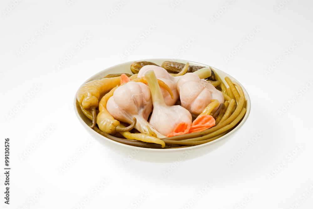The pickled vegetables on the plate. Shot on a light background.