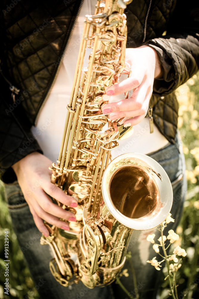 Fototapeta premium Woman playing saxophone i- detail