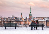 One winter afternoon at the Stockholm. Lovers at the hill of Sodermalm looking over the Stockholm Old Town (Gamla Stan). 