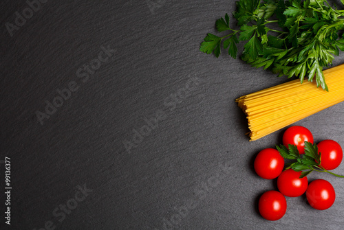 Raw pasta with tomatoes and parsley