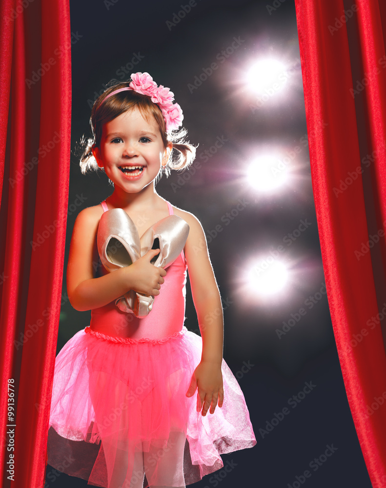 Obraz premium little girl ballerina ballet dancer on stage in red side scenes