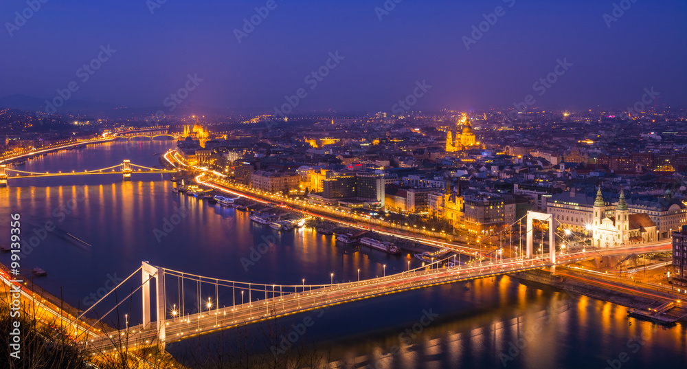 Cityscape view of Budapest capital in evening lights, bridge and landmarks illuminated in Hungary