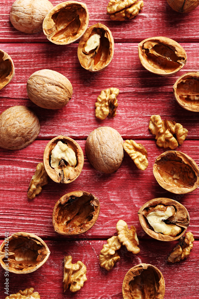 Walnuts on a red wooden table Walnuts on a red wooden table