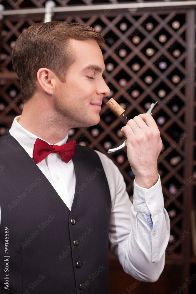 Attractive male wine waiter with a bottle-screw Attractive male wine waiter with a bottle-screw