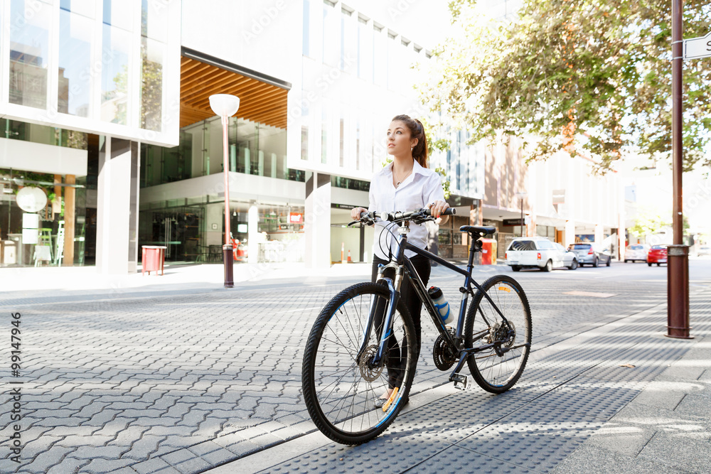 Portrait of happy young female bicyclist