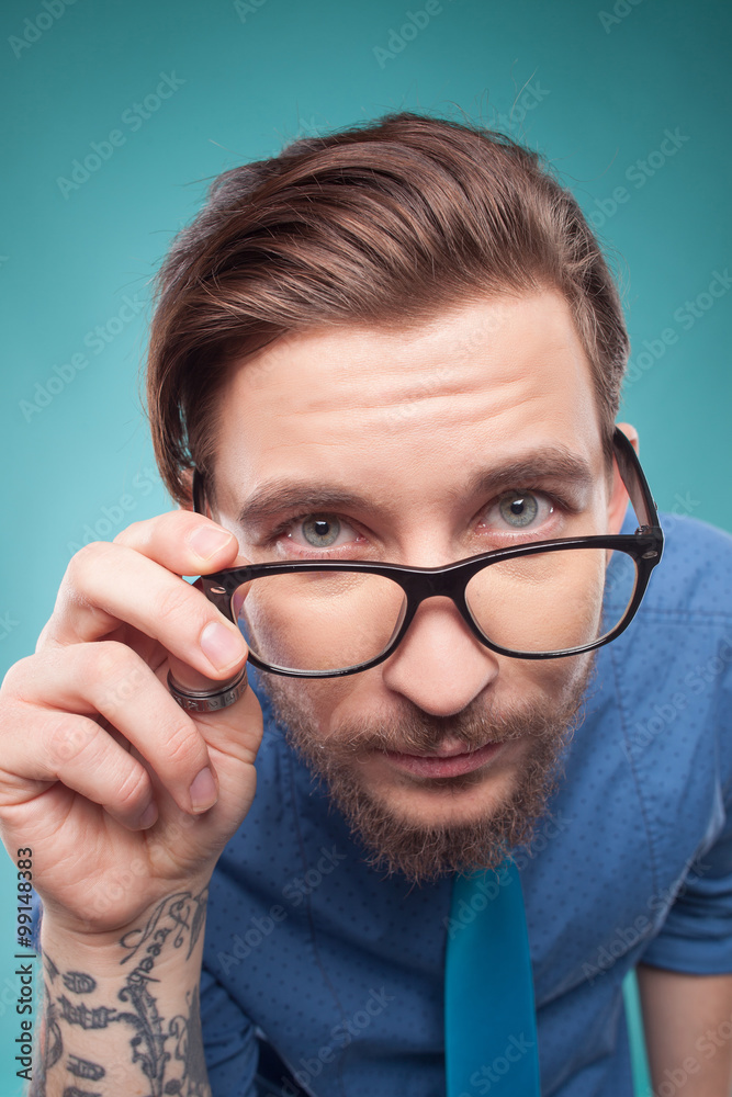Handsome young man is examining something interesting Handsome young man is examining something interesting