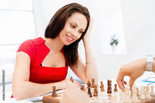 Business woman sitting in front of chess