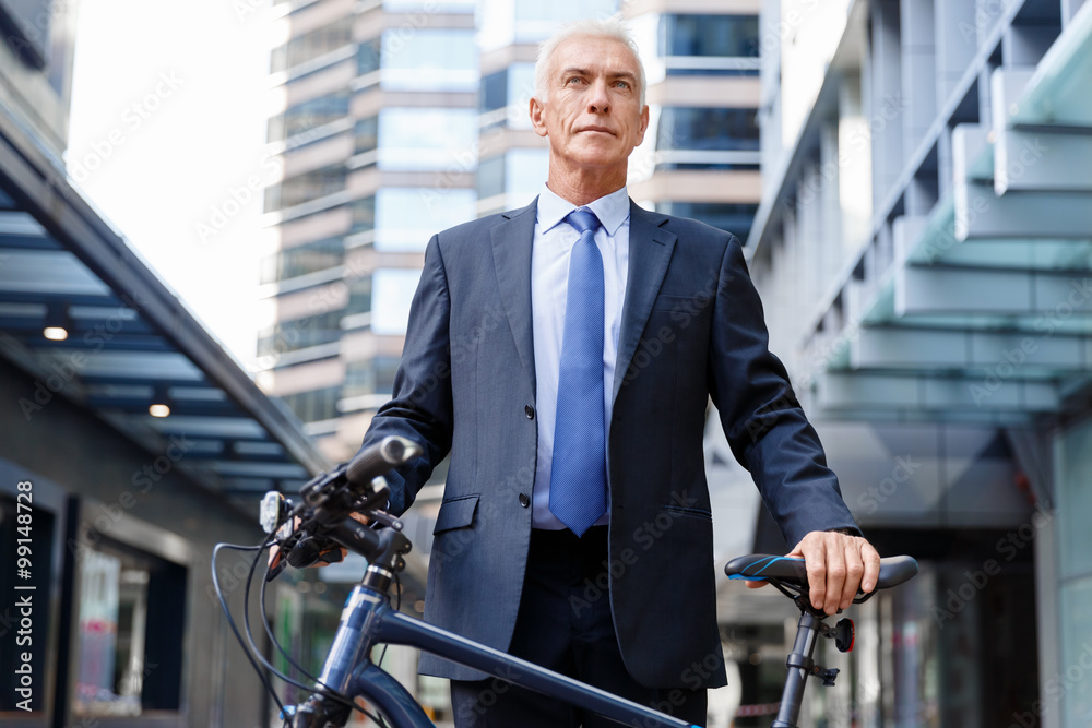 Successful businessman riding bicycle Successful businessman riding bicycle