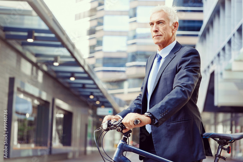 Successful businessman riding bicycle