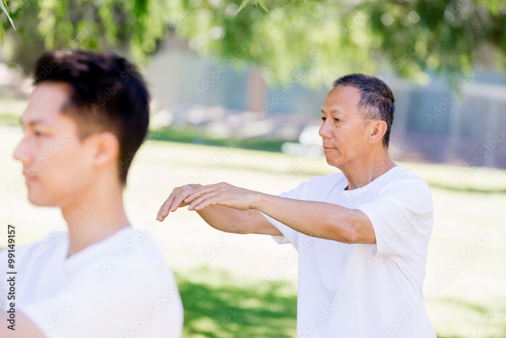 People practicing thai chi in park People practicing thai chi in park