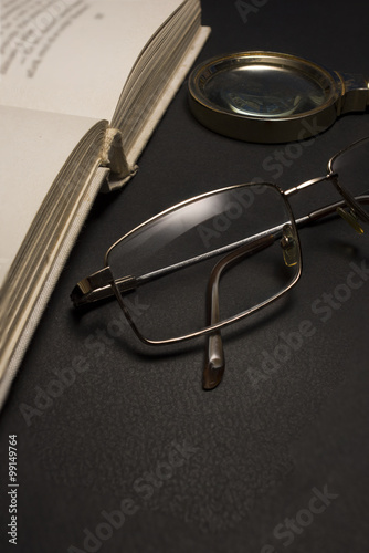 Ophthalmologist concept with book  eyeglasses and magnifying glass. High resolution image.