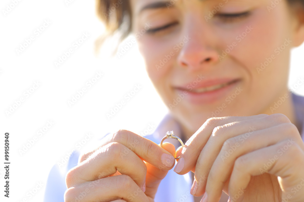Wunschmotiv: Sad girlfriend looking her engagement ring #99150940