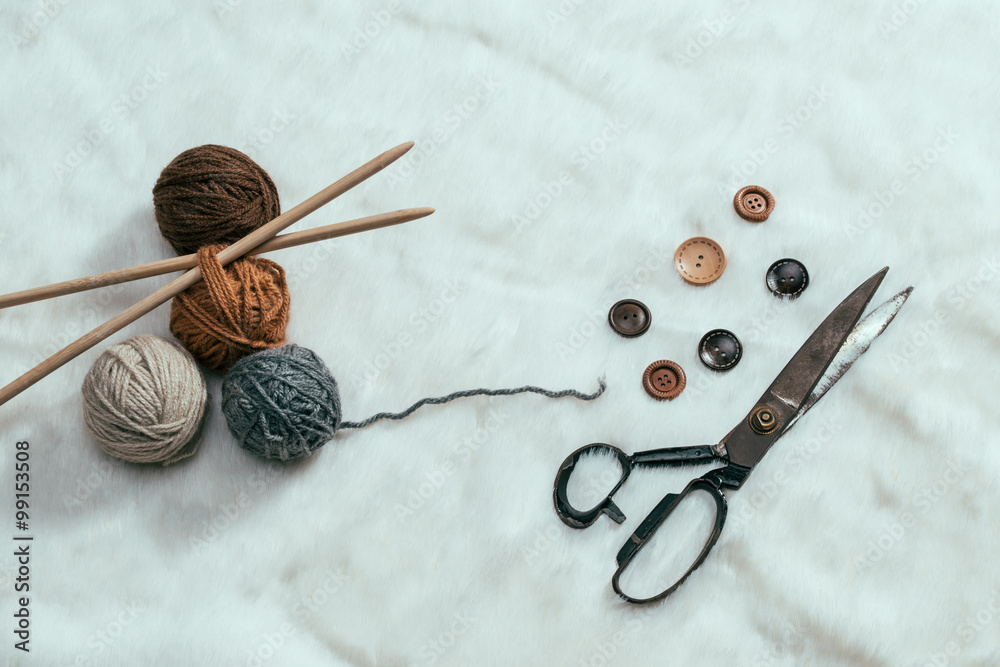 button, scissors and yarn ball on carpet button, scissors and yarn ball on carpet
