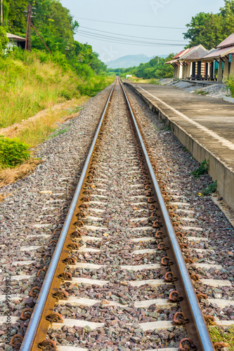 Straight train track nearby railway station in Thailand. The station is Pa Sak Chonlasit dam station.