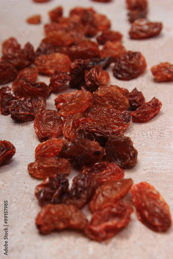 Fototapeta premium Brown raisins on structure of concrete, healthy eating