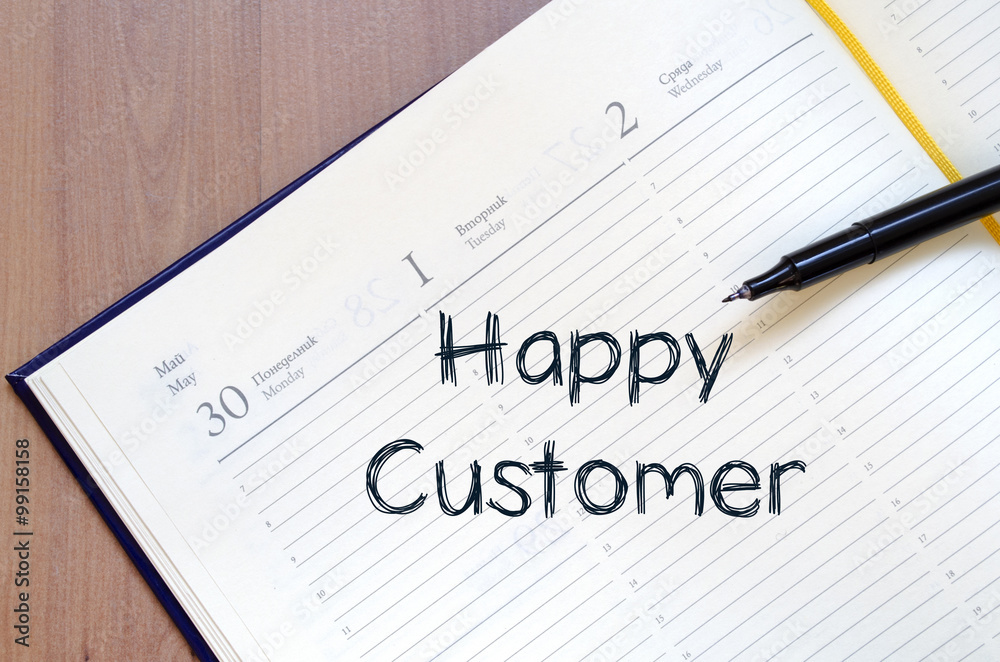 Happy customer write on notebook Happy customer write on notebook