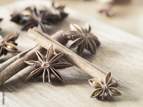 Star anise and cinnamon sticks on wooden chopping block