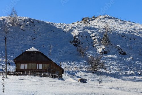 rustic house on a snowy field