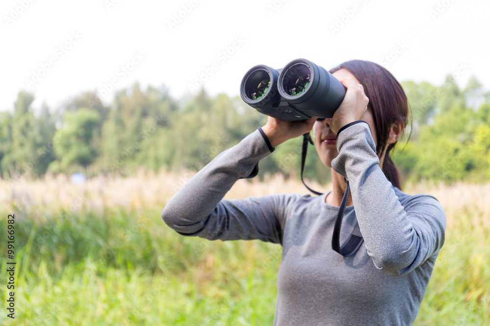 Asian Young woman watching though binoculars Asian Young woman watching though binoculars
