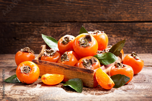 fresh persimmons in a box photo