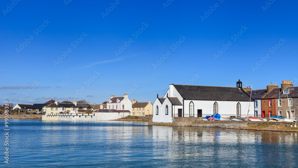 Fototapeta premium Isle of Whithorn Waterfront. The view across Isle of Whithorn Bay to the small coastal village of Isle of Whithorn in Dumfries and Galloway, Southern Scotland.