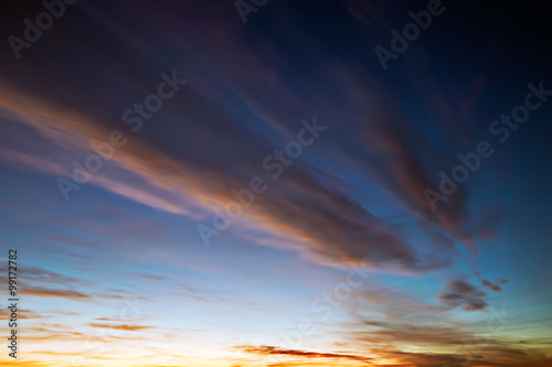 sky at sunset with orange clouds, light turns into darkness