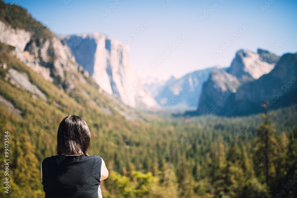 Travel in Yosemite Park, woman Hiker with backpack enjoying view, California, USA, caucasian