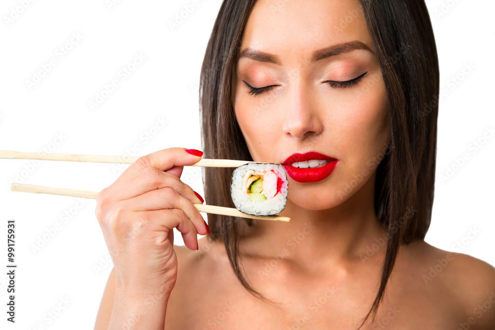 Young woman holding sushi with a chopsticks, isolated on white Young woman holding sushi with a chopsticks, isolated on white
