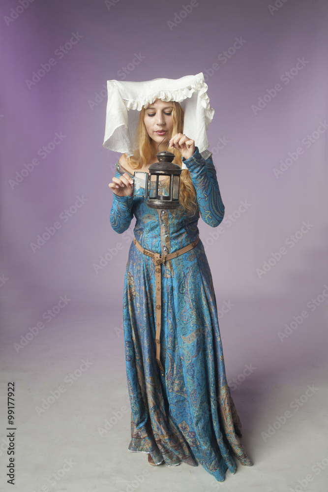 Medieval girl puts off a lamp