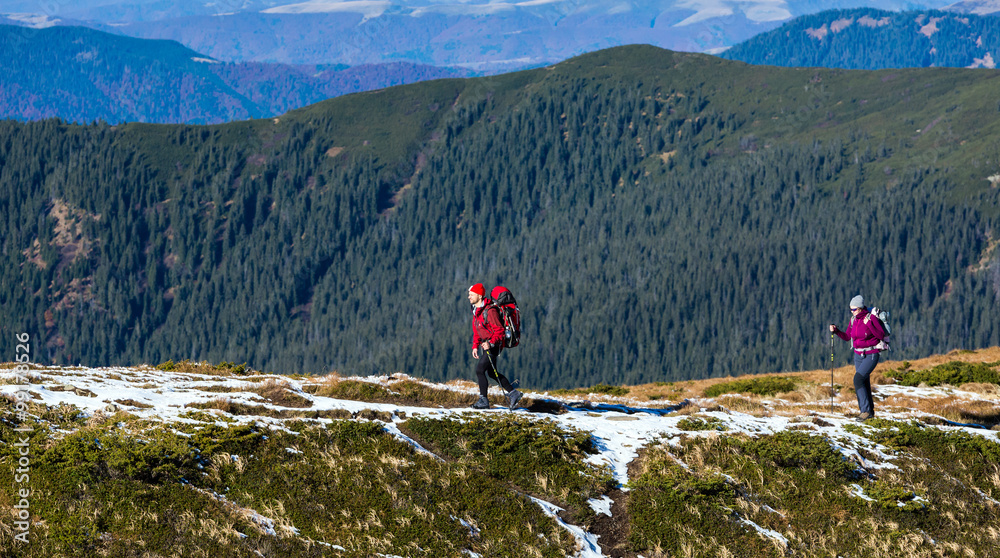 Two Hikers walking along Mountain ridge