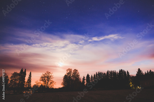 Night landscape and cloudy starry sky