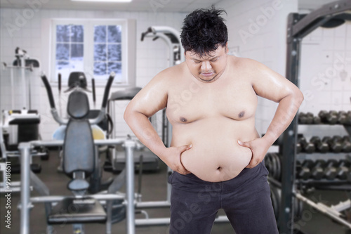 Overweight Man Grabbing his Fat