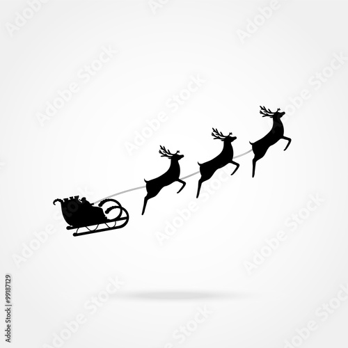 Santa Claus rides in a sleigh in harness on the reindeer