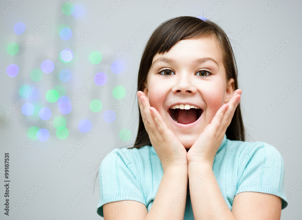 Girl is holding her face in astonishment Girl is holding her face in astonishment