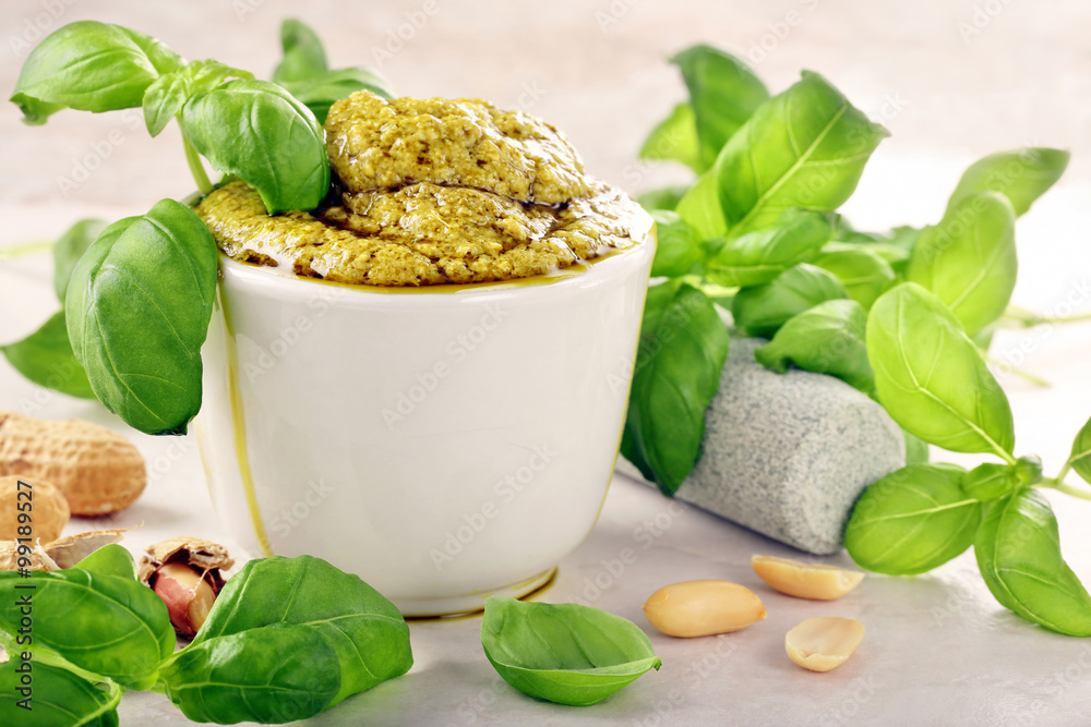 Green basil pesto in white bowl Green basil pesto in white bowl