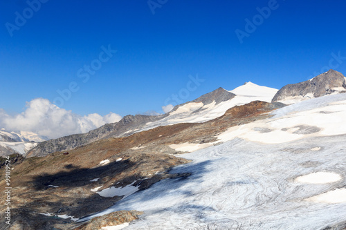 Mountain glacier panorama with summit Großvenediger south face and alpine hut Defreggerhaus in the Hohe Tauern Alps, Austria