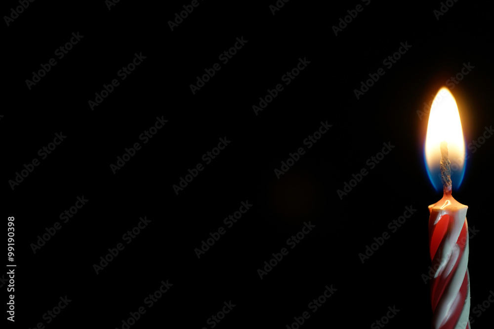 burning candle isolated on black burning candle isolated on black