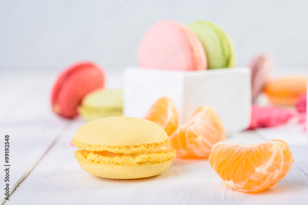French Macaroons With Tangerine Slices On Wood Table French Macaroons With Tangerine Slices On Wood Table