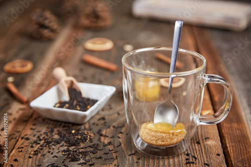 Fotografie Brown sugar and honey in a tea glass and cinnamon and orange sli