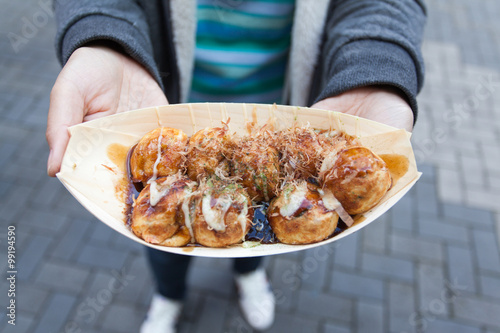 close up takoyaki on hand women in Osaka Japan