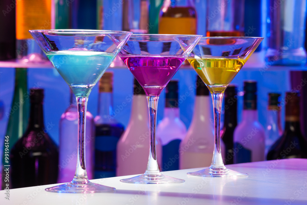 Set of color cocktail martini glasses in the bar