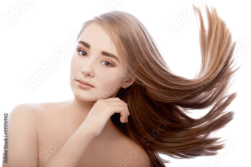 Very young girl with bushy hair flying on strong wind.