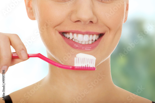 Woman with toothbrush.