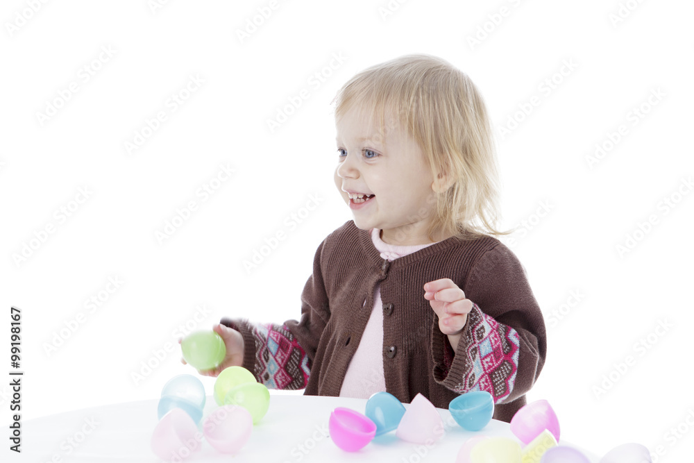 Little girl playing with Easter eggs, isolated on white background Little girl playing with Easter eggs, isolated on white background