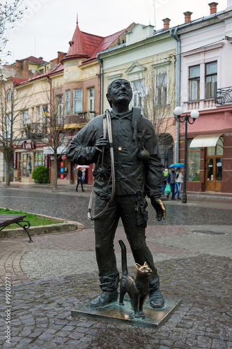 Mukachevo, Ukraine - April 6, 2015: Monument of Happy Chimney Sweeper and his cat. The monument with real chimney sweeper Bertalon Tovt by Ukrainian sculptor Ivan Brovdi. photo
