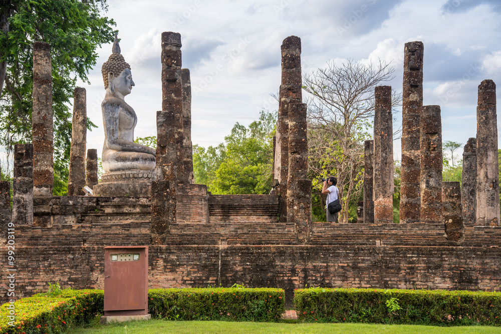 Photographer take a picture of buddha image at Sukhothai histori