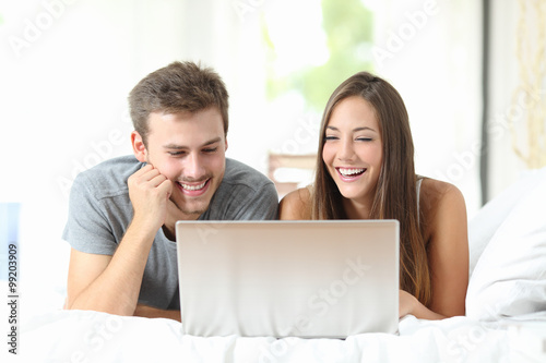 Couple watching videos on a laptop at home