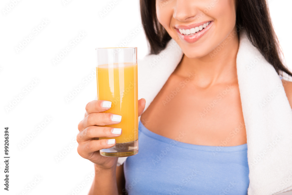 Cheerful smiling girl with towel holding a glass of orange juice Cheerful smiling girl with towel holding a glass of orange juice