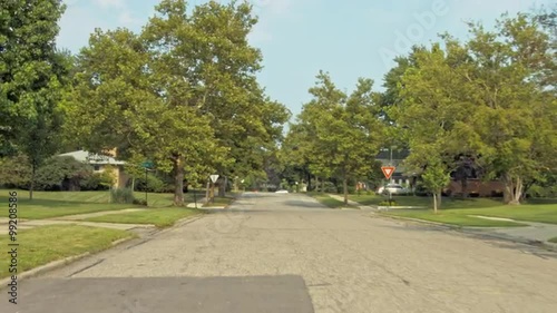 Driving plate: rear view, 1950s-70s single-storey, ranch-style houses in Mid West US neighborhood.  Intended for compositing.  24mm lens, stabilized clip, moderate speed